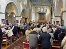 2025_04_13 Palm Sunday IMG_6169 A packed congregation in St Thomas' waving their palm crosses